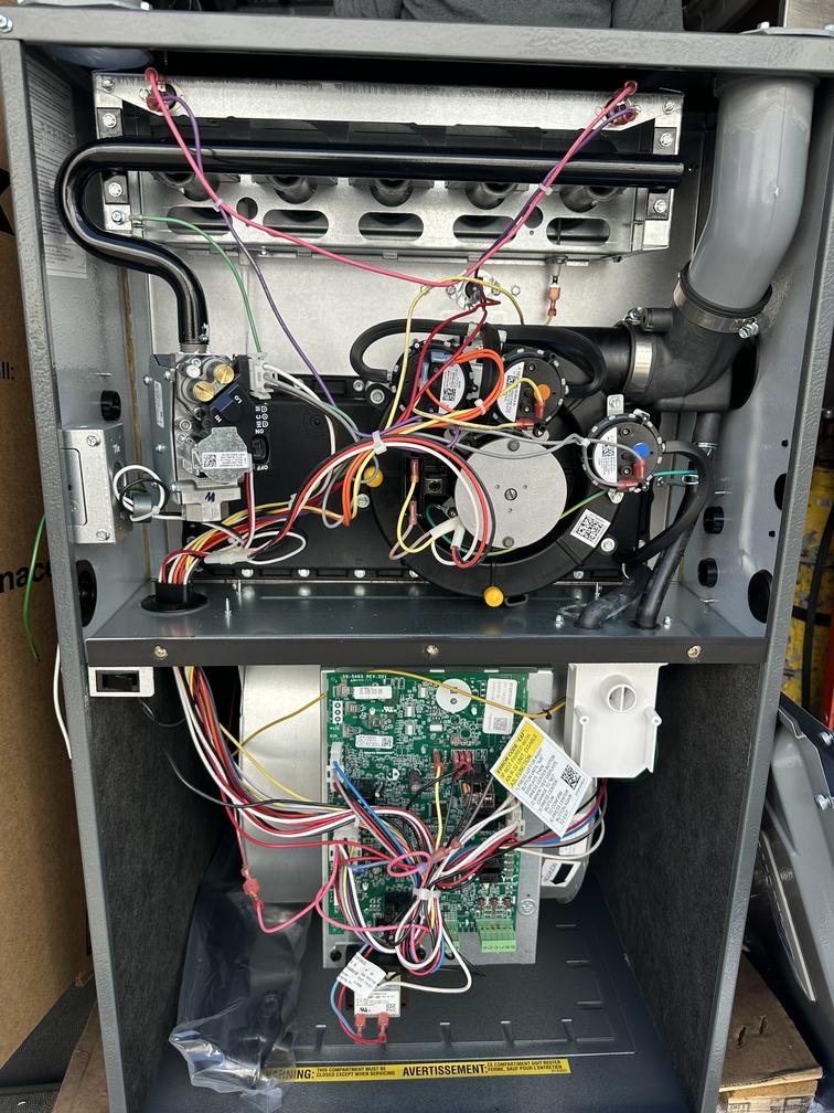Gas furnace installed as backup heat for a heat pump in a dual-fuel system in Moraga, front panels off